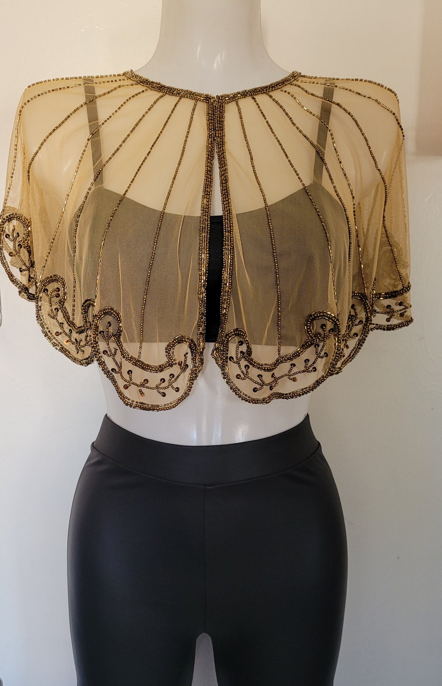 Bolero capelet with gold beads all over. Inspired in Gatsby 1920's . Really romantic style and beautiful short cape. Hand made embroidery .One size only. Art Deco cape embellished with gold beads, sequins with hook and eye button. Round neck.
