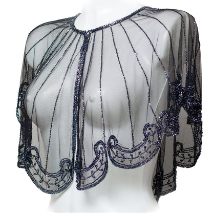 Sheer black beaded top on a mannequin against a white background